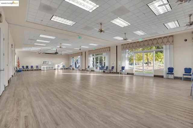 a living room with furniture and a book shelf