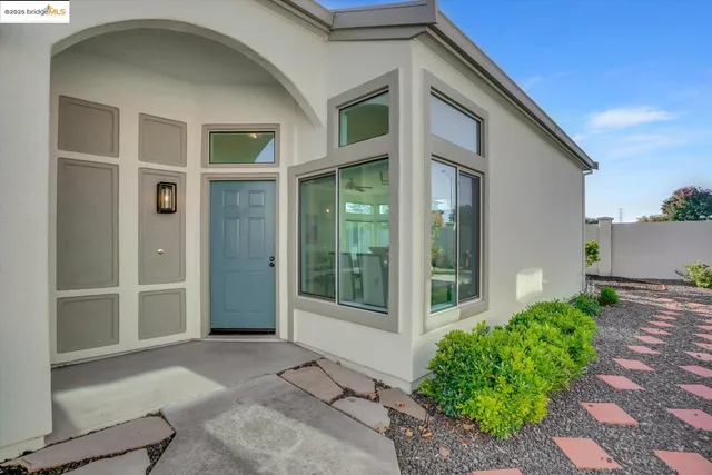 a view of a brick house with large windows