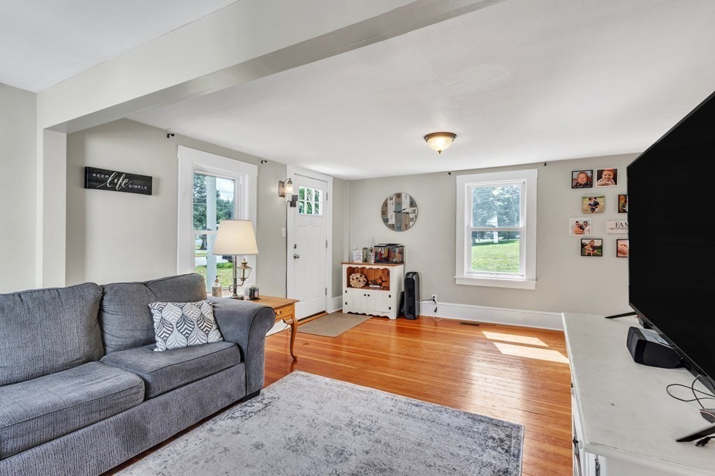 153 Pomeroy Meadow Road Southampton, MA 01073 - Photo 13 of 42 a living room with furniture and a flat screen tv