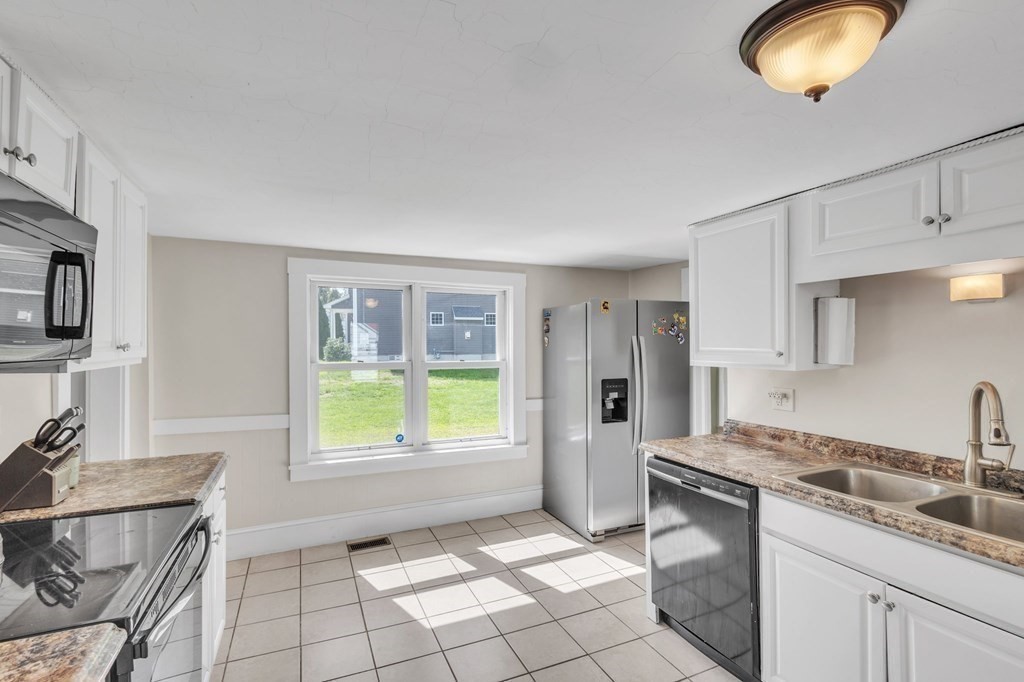 153 Pomeroy Meadow Road Southampton, MA 01073 - Photo 14 of 42 a kitchen with a sink cabinets and window