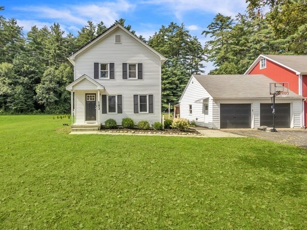 153 Pomeroy Meadow Road Southampton, MA 01073 - Photo 2 of 42 a front view of a house with a garden and yard