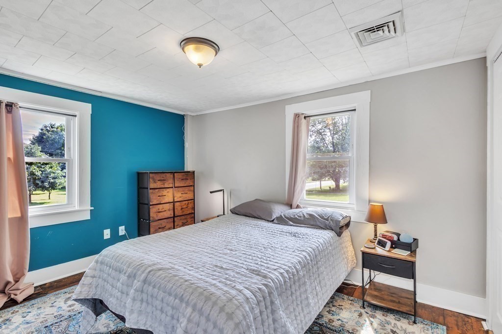 153 Pomeroy Meadow Road Southampton, MA 01073 - Photo 23 of 42 a bedroom with a bed and wooden floor