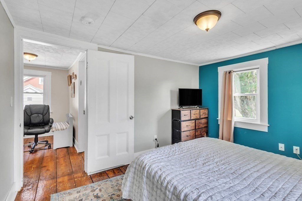 153 Pomeroy Meadow Road Southampton, MA 01073 - Photo 24 of 42 a bedroom with a bed and a flat screen tv