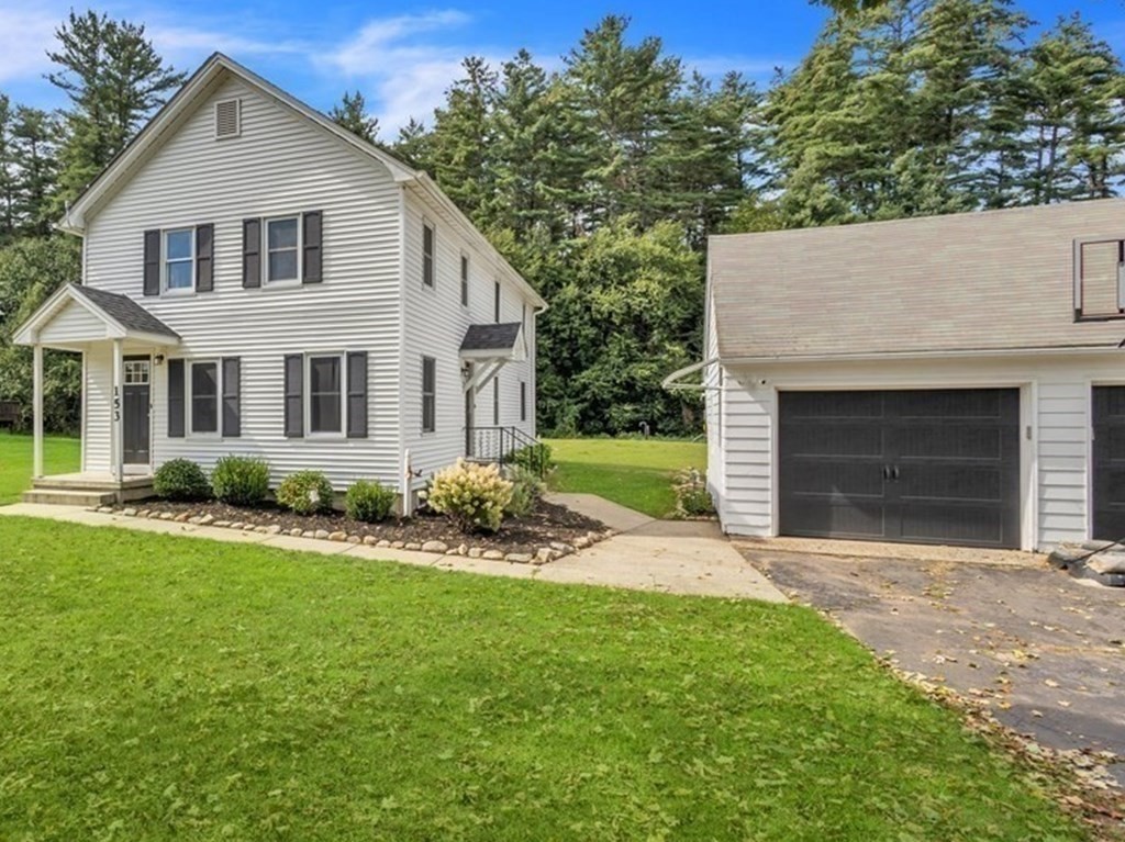 153 Pomeroy Meadow Road Southampton, MA 01073 - Photo 3 of 42 a front view of a house with a garden and yard