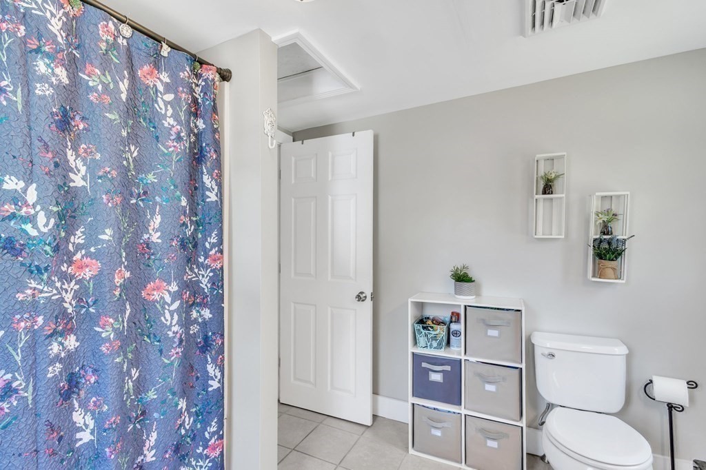153 Pomeroy Meadow Road Southampton, MA 01073 - Photo 33 of 42 a white toilet sitting next to a shower curtain