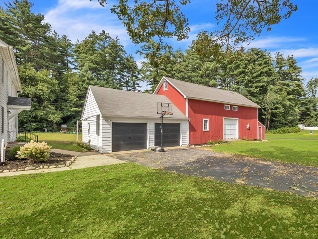 153 Pomeroy Meadow Road Southampton, MA 01073 - Photo 5 of 42 a front view of a house with a yard and garage