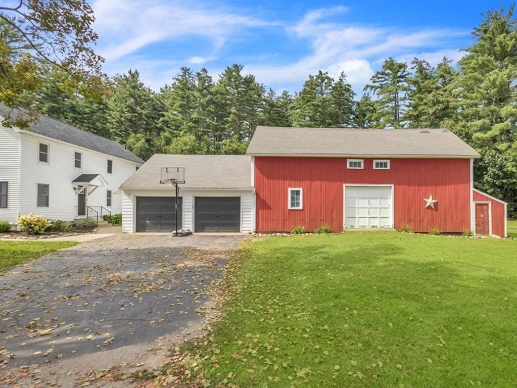 153 Pomeroy Meadow Road Southampton, MA 01073 - Photo 10 of 42 a front view of a house with a yard and garage