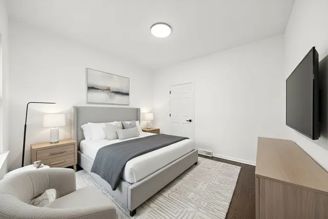 a bedroom with a bed and a flat screen tv