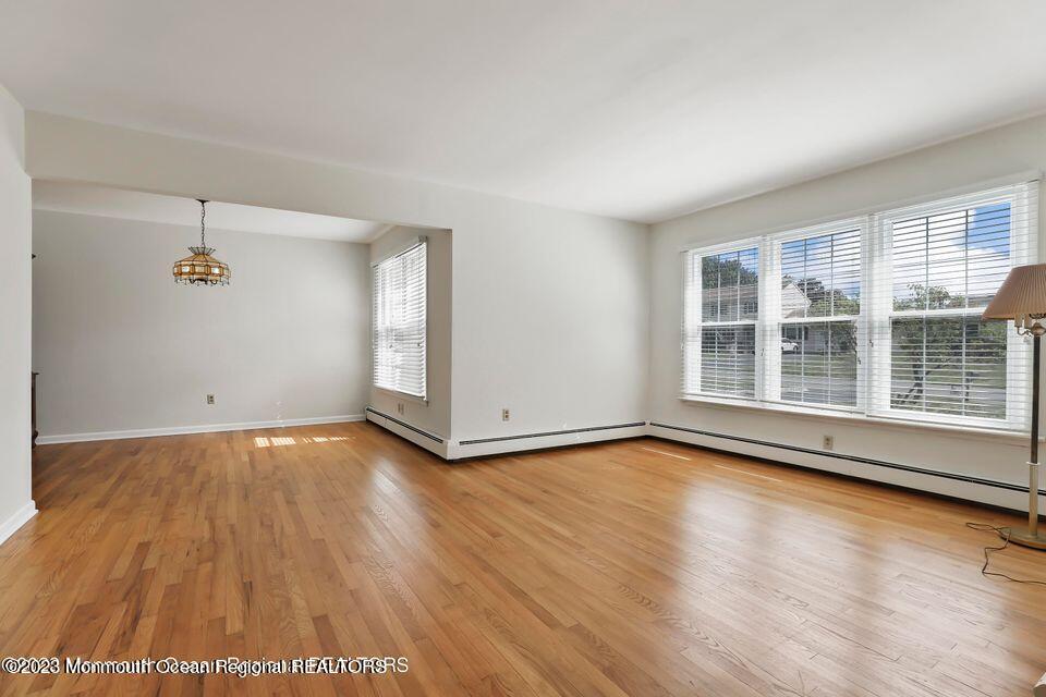 22 Glenmore Road Freehold, NJ 07728 - Photo 3 of 22 an empty room with wooden floor and windows
