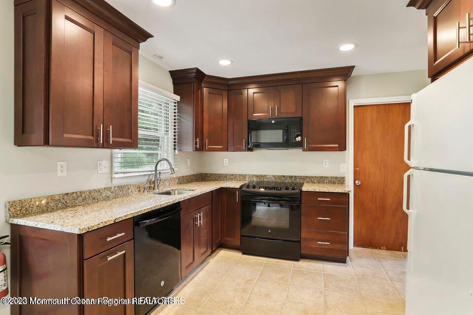 22 Glenmore Road Freehold, NJ 07728 - Photo 6 of 22 a kitchen with a sink and a refrigerator