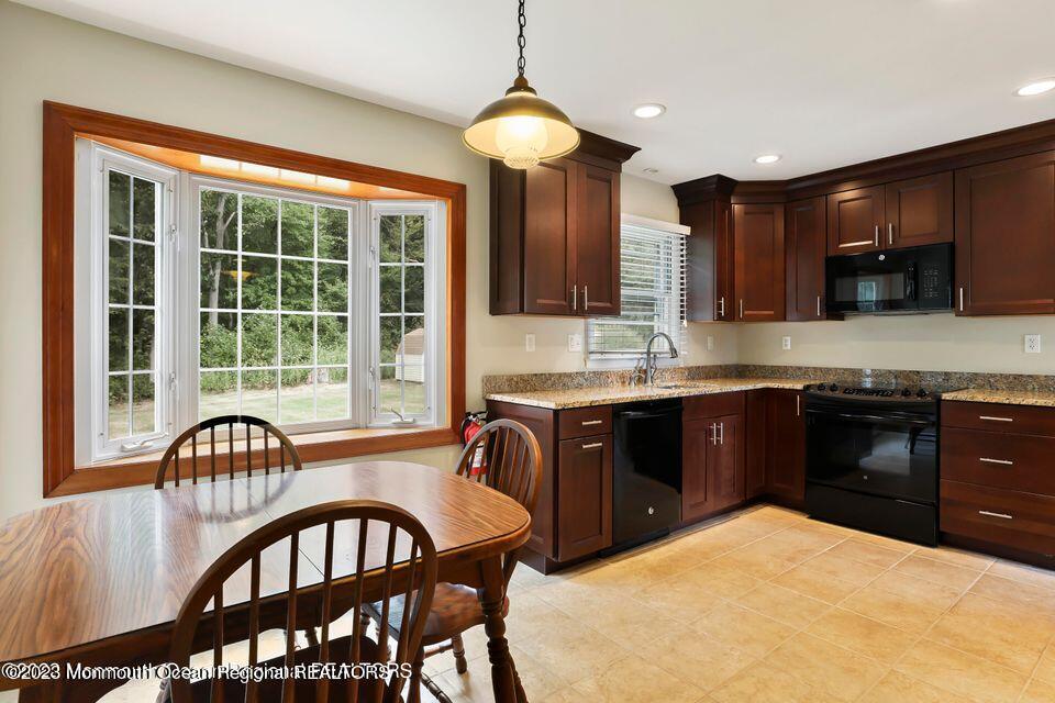 22 Glenmore Road Freehold, NJ 07728 - Photo 7 of 22 a kitchen with a stove a sink and a refrigerator