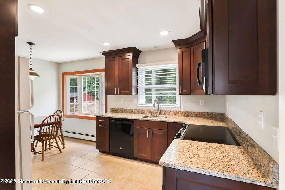 22 Glenmore Road Freehold, NJ 07728 - Photo 8 of 22 a kitchen with a sink stove and table