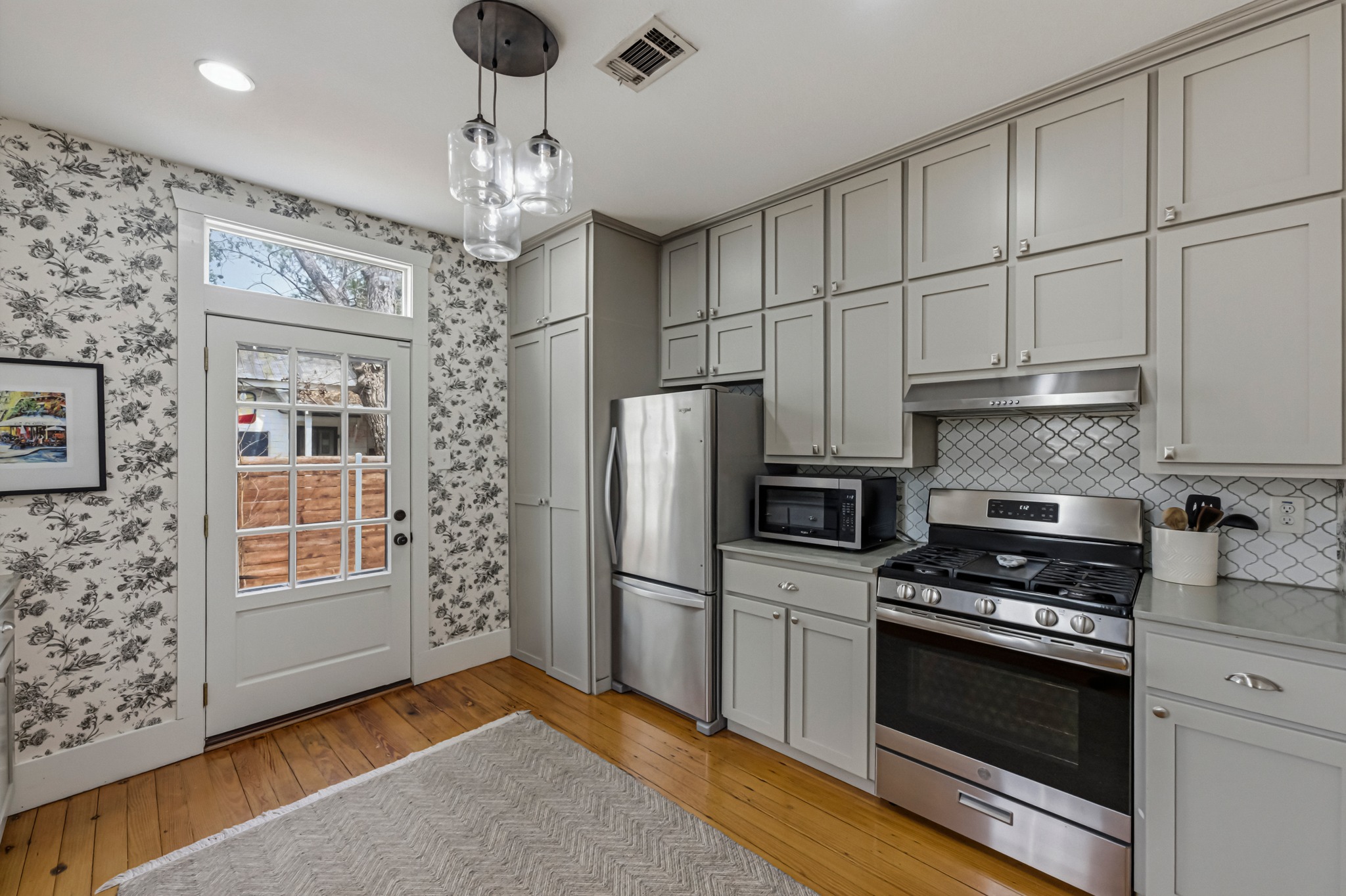 306 West 44th Street, Unit A Austin, TX 78751 - Photo 17 of 38 a kitchen with stainless steel appliances granite countertop a refrigerator and a stove top oven