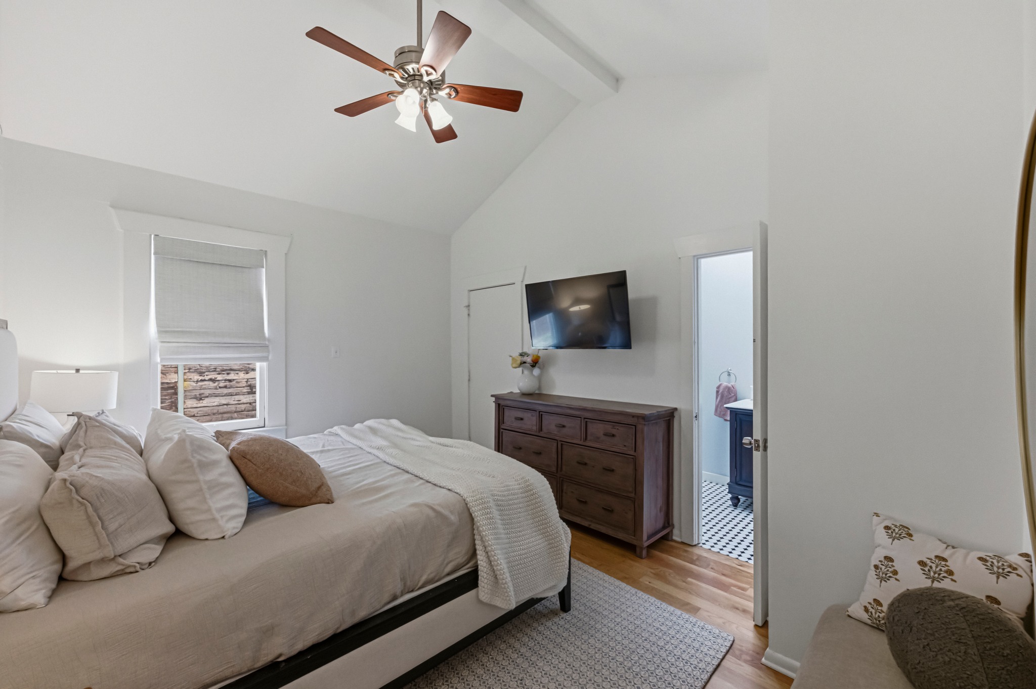 306 West 44th Street, Unit A Austin, TX 78751 - Photo 22 of 38 a bedroom with a bed and a flat screen tv