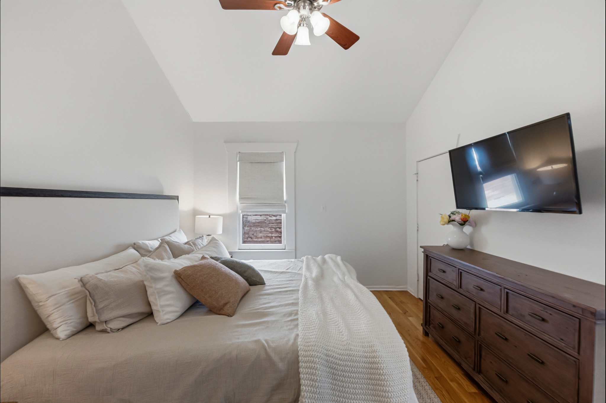 306 West 44th Street, Unit A Austin, TX 78751 - Photo 23 of 38 a bedroom with a bed and a flat tv screen on dresser