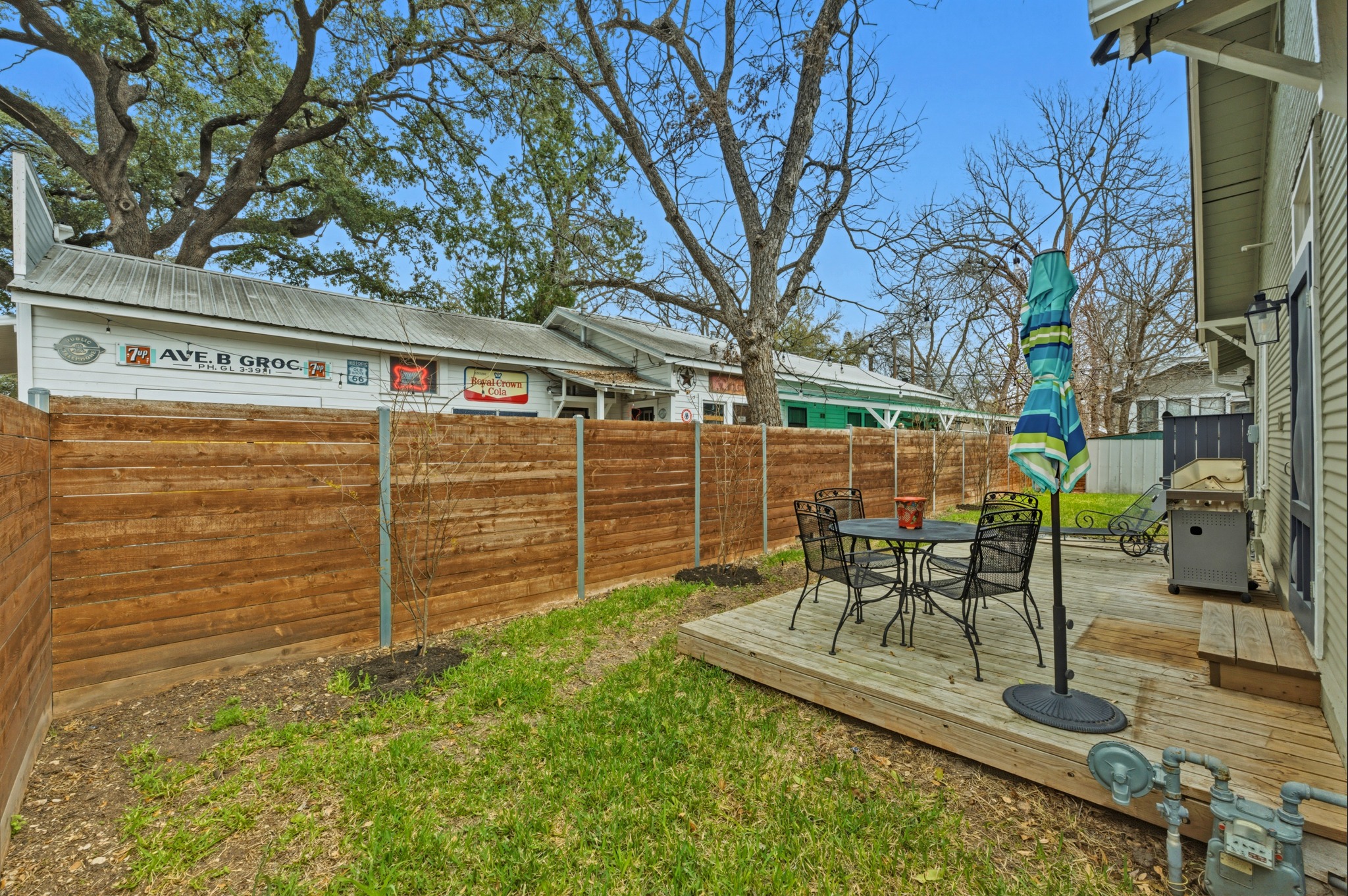306 West 44th Street, Unit A Austin, TX 78751 - Photo 33 of 38 a view of a patio with table and chairs and wooden fence