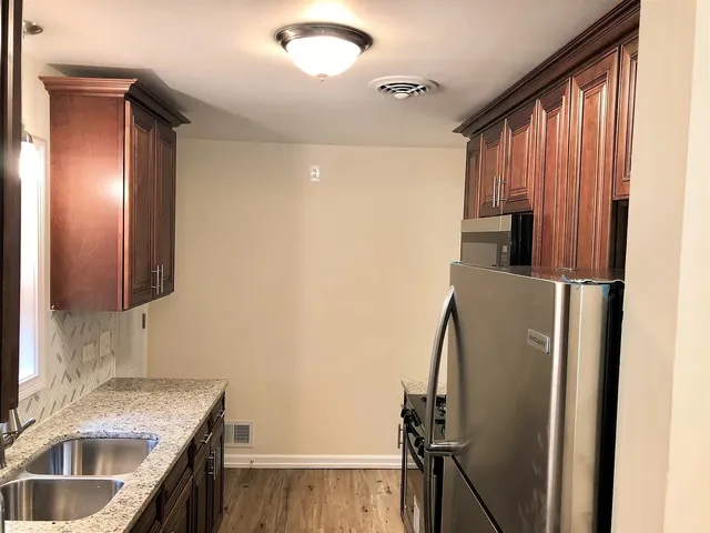 a kitchen with a refrigerator and a sink