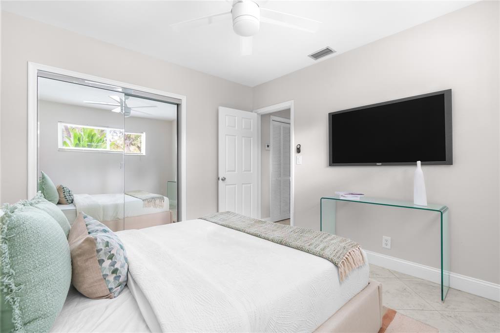 1502 Southwest 24th Street, Unit A Fort Lauderdale, FL 33315 - Photo 16 of 23 a bedroom with a bed and a flat screen tv