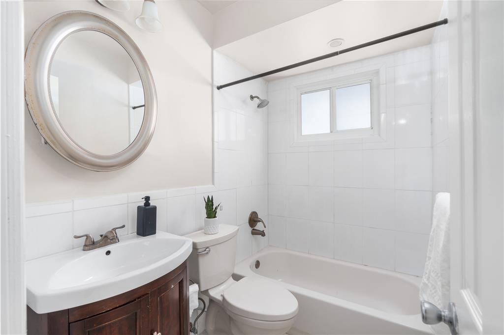 1502 Southwest 24th Street, Unit A Fort Lauderdale, FL 33315 - Photo 17 of 23 a bathroom with a bathtub shower sink vanity mirror and toilet