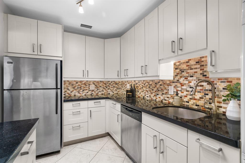 1502 Southwest 24th Street, Unit A Fort Lauderdale, FL 33315 - Photo 6 of 23 a kitchen with sink a refrigerator and cabinets