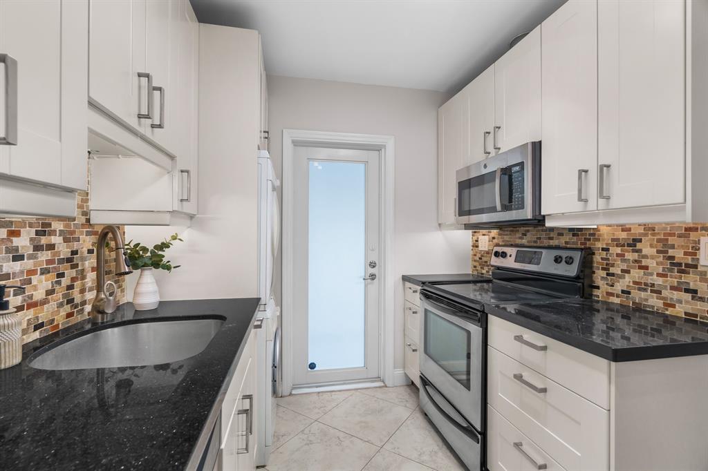 1502 Southwest 24th Street, Unit A Fort Lauderdale, FL 33315 - Photo 8 of 23 a kitchen with stainless steel appliances granite countertop a sink stove and microwave