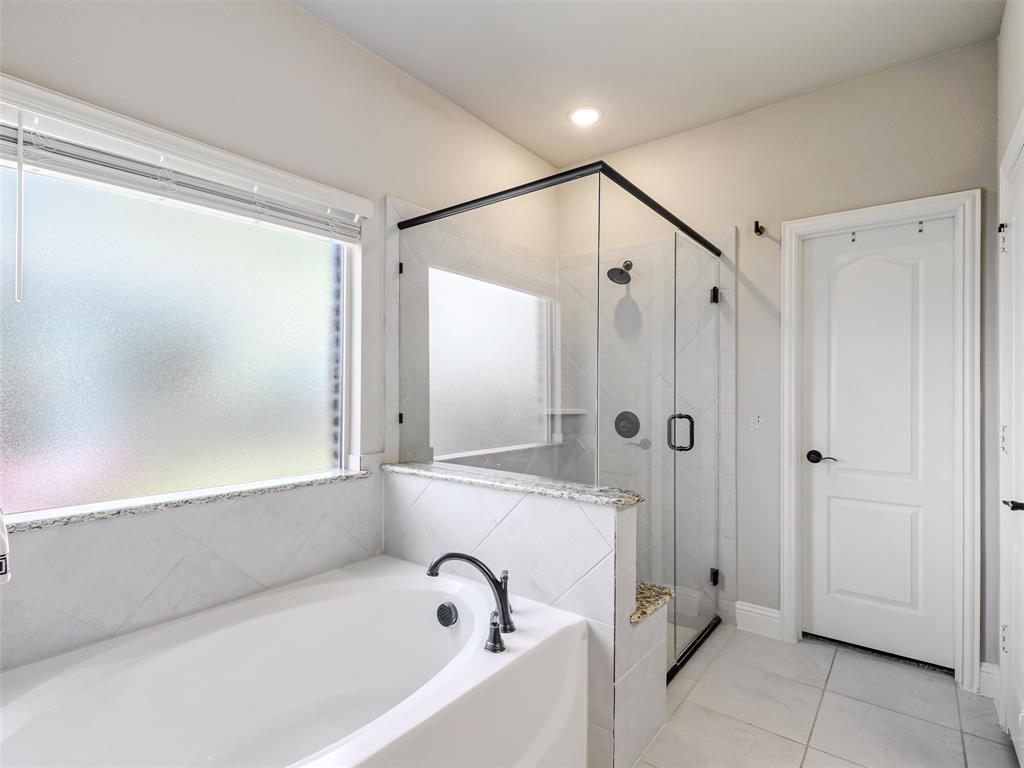 1216 Tree Shadow Lane Anna, TX 75409 - Photo 20 of 37 a bathroom with a bathtub and a shower