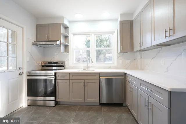 a kitchen with white cabinets and white appliances