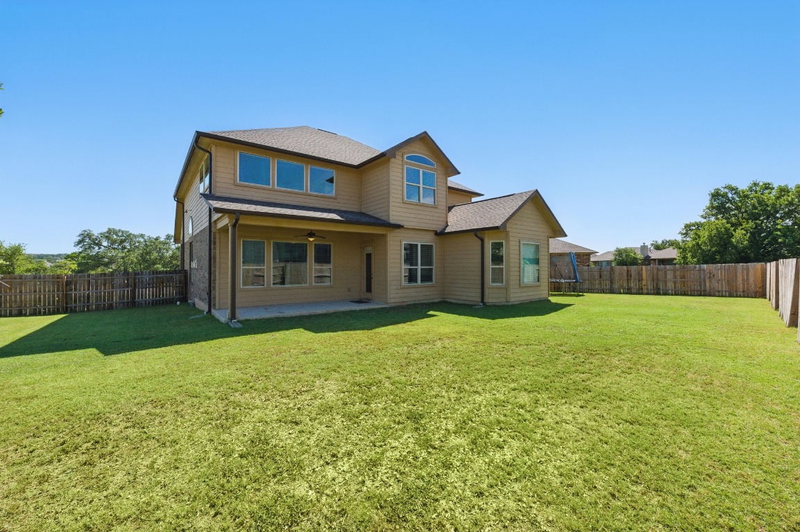 143 Pink Granite Boulevard Dripping Springs, TX 78620 - Photo 27 of 35 a front view of a house with garden
