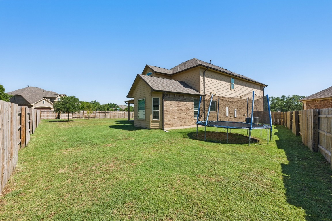 143 Pink Granite Boulevard Dripping Springs, TX 78620 - Photo 29 of 35 a view of a house with a yard and deck