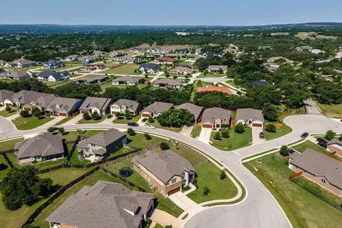 an aerial view of residential houses with outdoor space