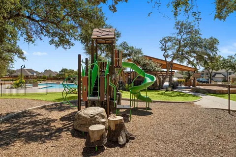 a view of a park with swings and slides