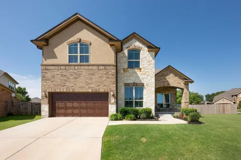 a front view of a house with a yard and garage