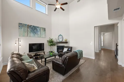a living room with furniture a fireplace and a chandelier