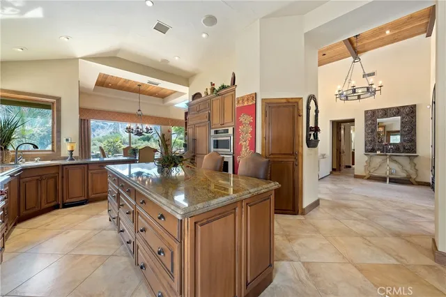 a kitchen with stainless steel appliances granite countertop a sink a oven and a refrigerator