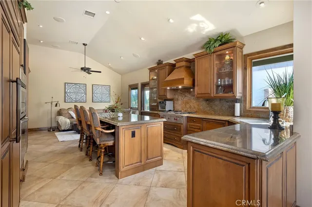 a kitchen with a stove a refrigerator and a dining table