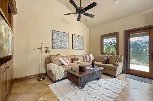 a bed sitting in a spacious bedroom next to a window