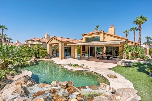 a view of a house with backyard garden and swimming pool