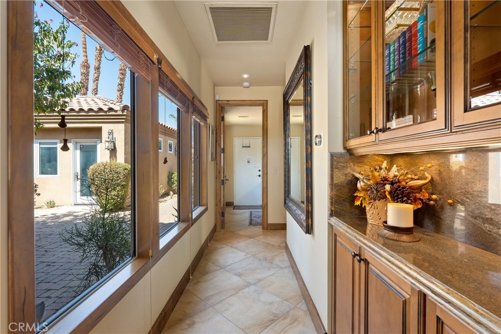 57205 Merion La Quinta, CA 92253 - Photo 29 of 53 Hallway to bedroom 3 + ensuite, laundry area and garage.