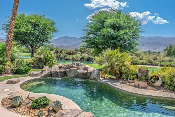 a view of a patio with table and chairs and potted plants