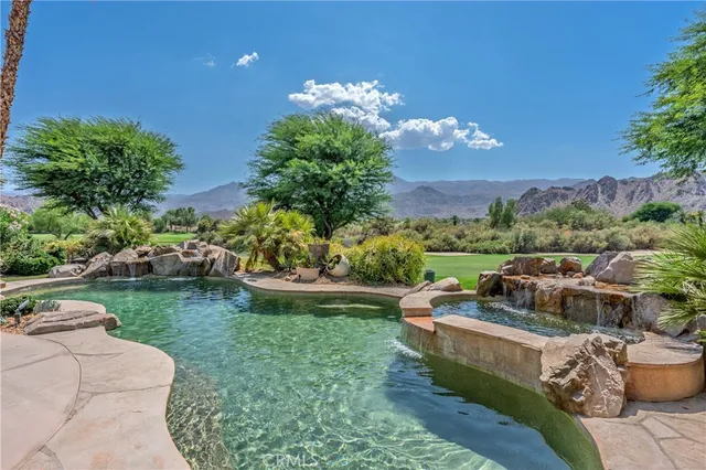 a view of a backyard with plants and outdoor seating