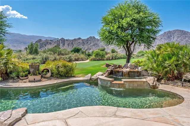 a view of a patio with a table and chairs