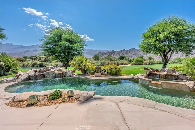 a view of a patio with table and chairs with wooden floor and fence