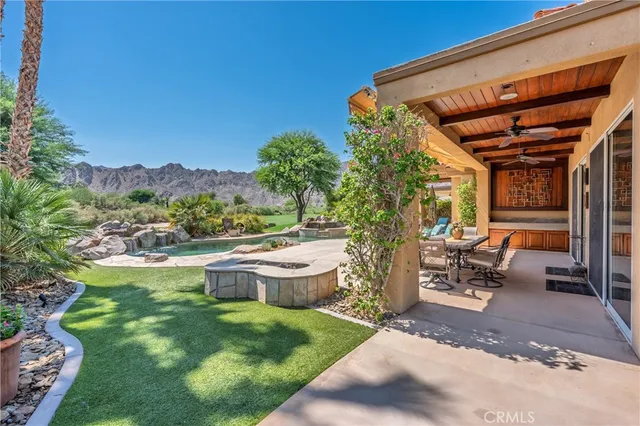 a view of a patio with table and chairs and potted plants