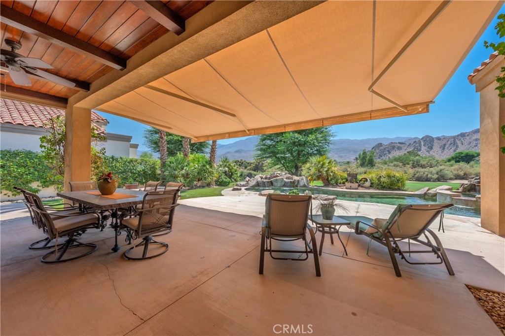 57205 Merion La Quinta, CA 92253 - Photo 46 of 55 a view of a patio with table and chairs and potted plants