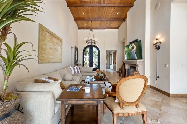 a dining room with furniture a chandelier and wooden floor