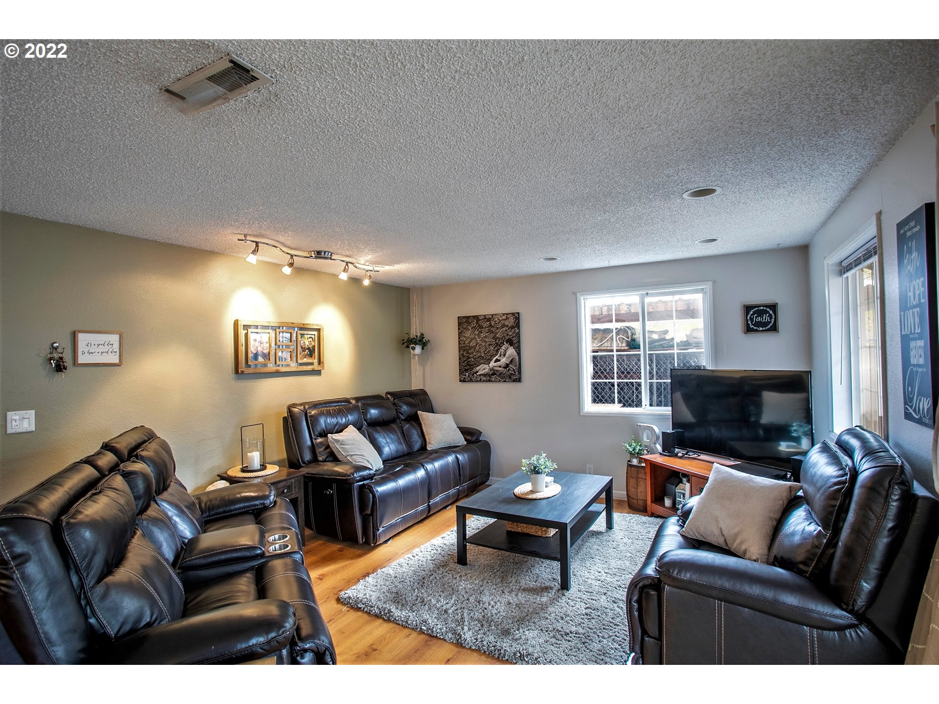 6305 C Street Springfield, OR 97478 - Photo 13 of 32 a living room with furniture a fireplace and a window