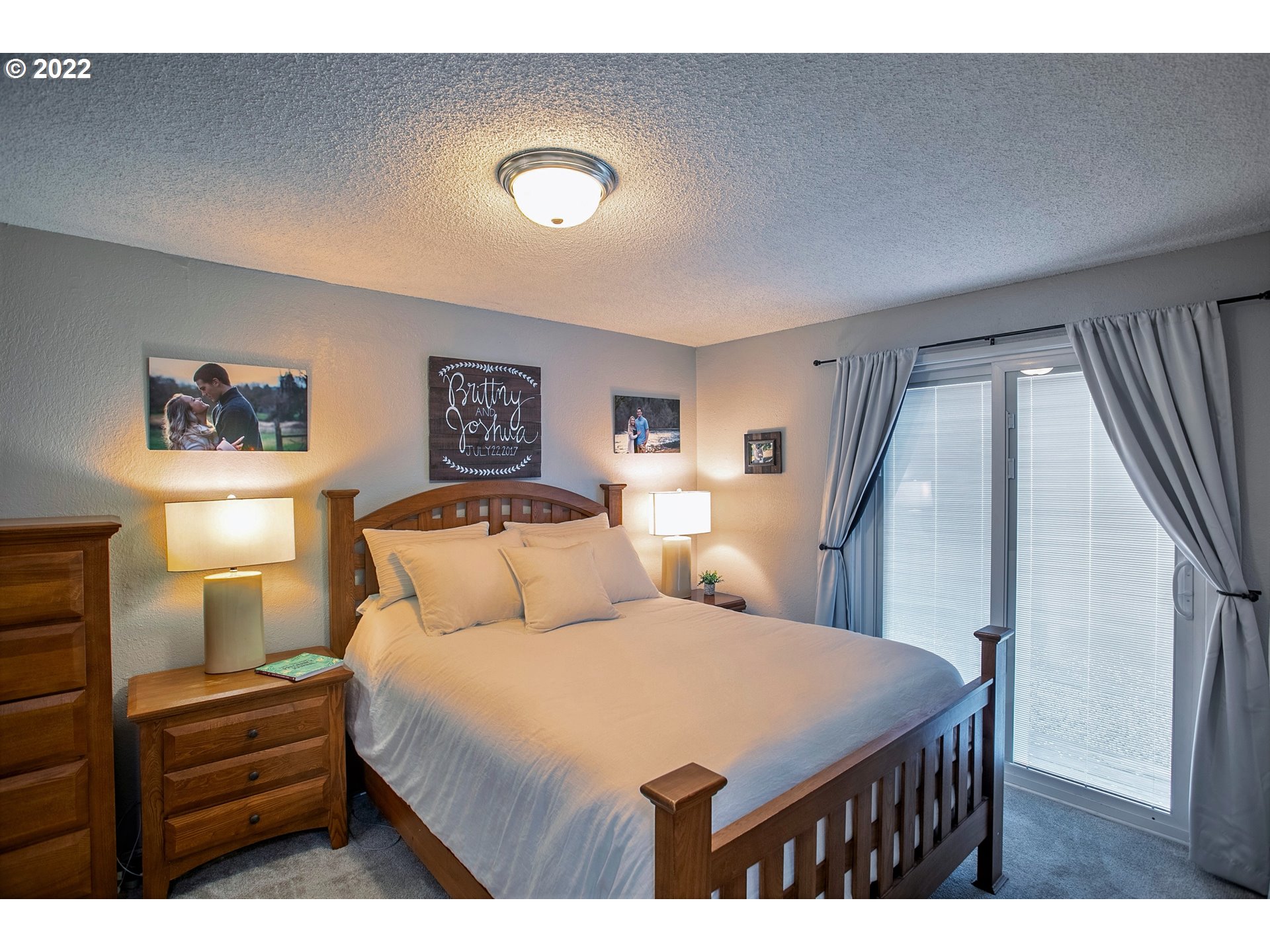 6305 C Street Springfield, OR 97478 - Photo 22 of 32 a bedroom with a large bed and a chandelier