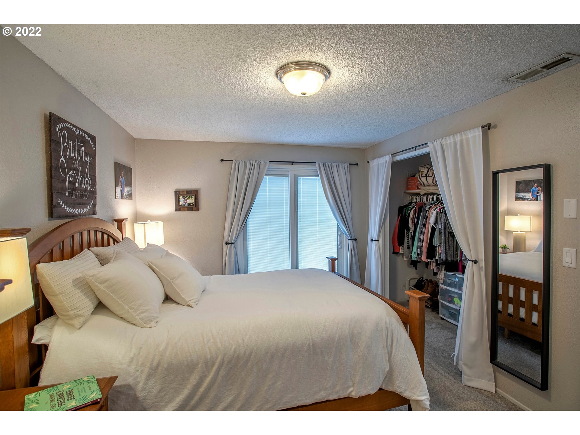 6305 C Street Springfield, OR 97478 - Photo 23 of 32 a bedroom with a bed and a large mirror