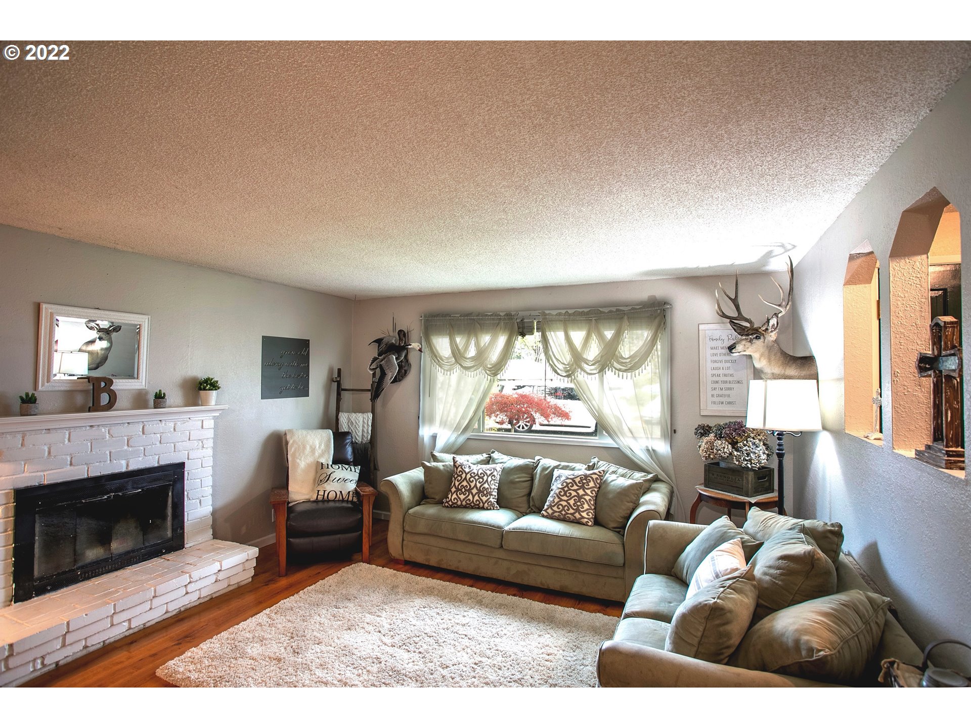 6305 C Street Springfield, OR 97478 - Photo 5 of 32 a living room with furniture and a fireplace