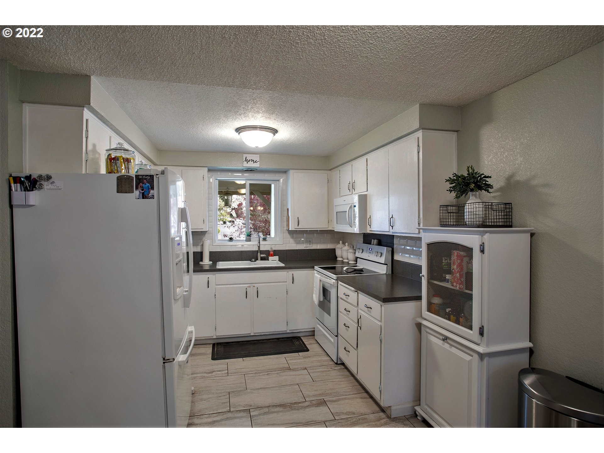 6305 C Street Springfield, OR 97478 - Photo 8 of 32 a kitchen with cabinets and stainless steel appliances